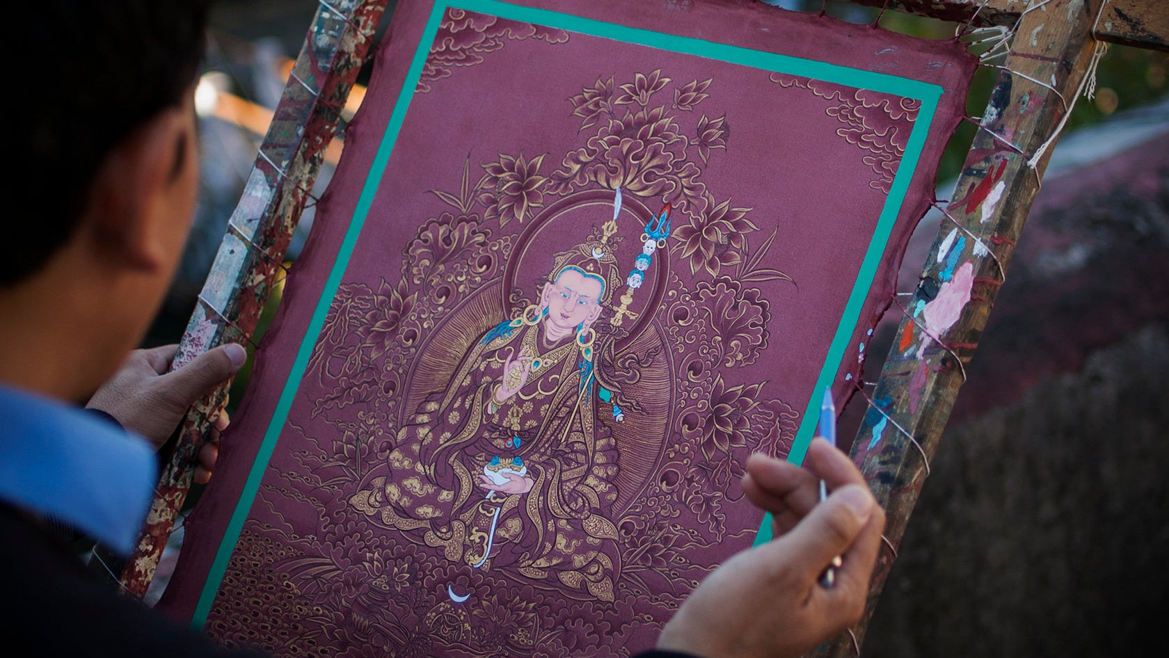 Artist painting a thangka